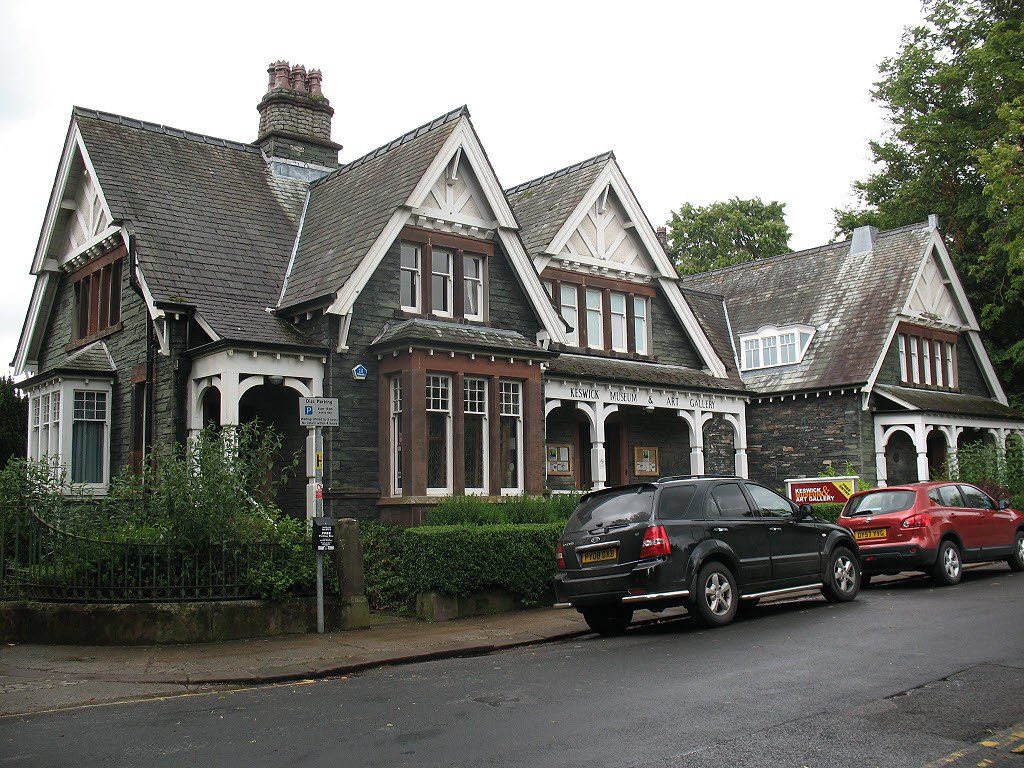 a house with cars parked on the side of the road