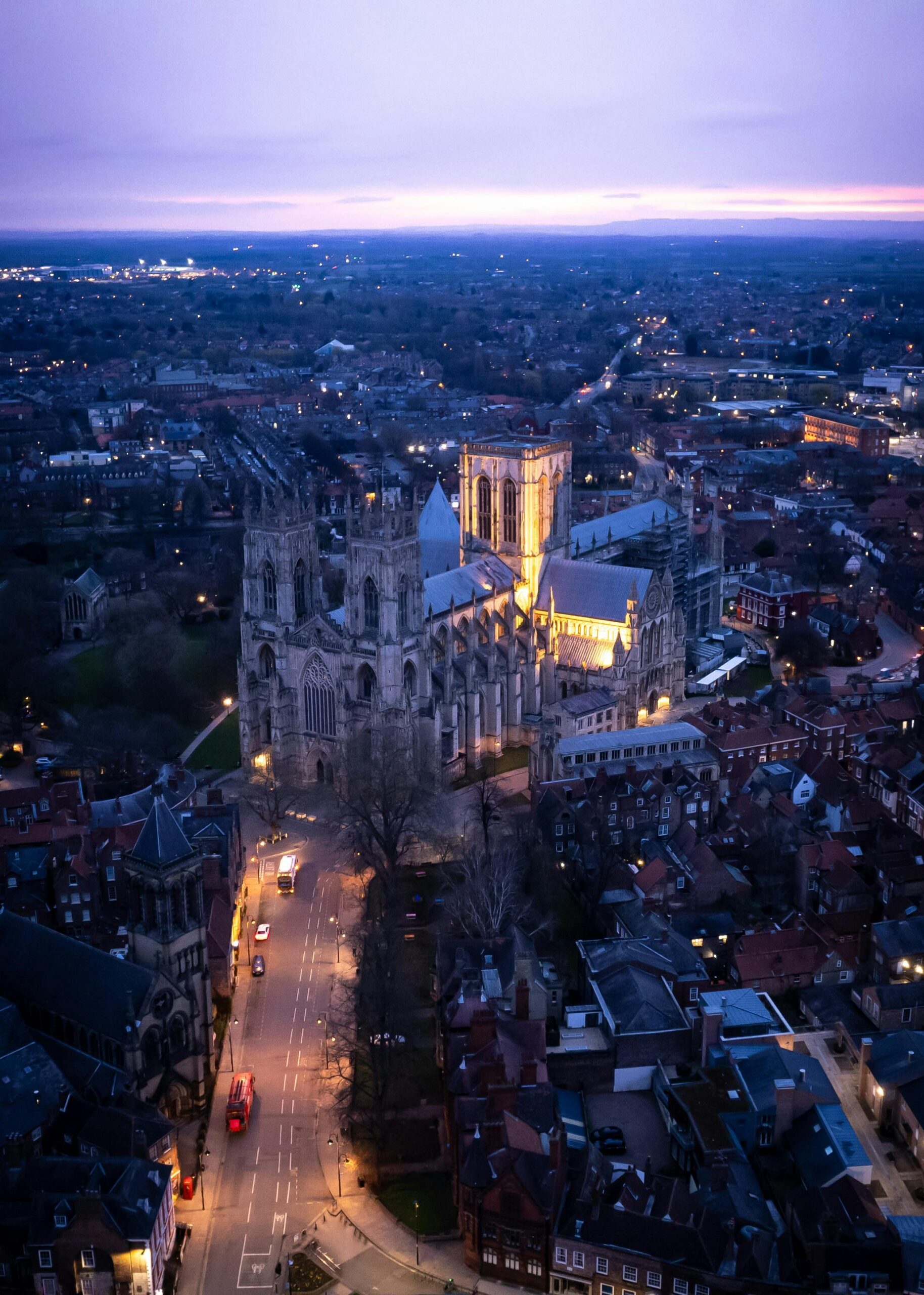 an aerial view of a large building with a city in the background