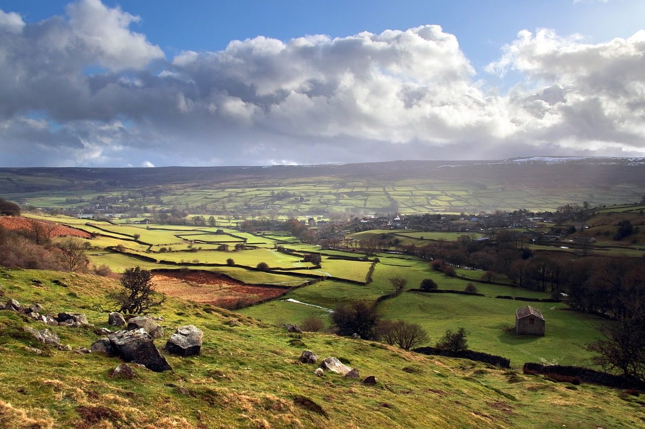 a landscape with a small house and a valley in the Yorkshire Dales